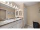 Double vanity bathroom with granite countertop and mirrors at 13076 Sw 38Th Ter, Ocala, FL 34473