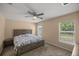 Bright bedroom featuring a king-size bed and window at 13076 Sw 38Th Ter, Ocala, FL 34473