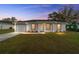 Newly built home with gray roof, white exterior and well-manicured lawn at 13187 Sw 103 Pl, Dunnellon, FL 34432