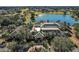 Aerial view of community clubhouse with expansive patio and lake view at 13309 Se 92Nd Court Rd, Summerfield, FL 34491