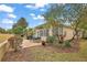 Landscaped patio with seating area and screened enclosure at 13309 Se 92Nd Court Rd, Summerfield, FL 34491