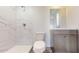 Clean bathroom featuring marble shower, vanity, and wood-look floors at 15551 Sw 150Th Pl, Ocala, FL 34481