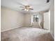 Spacious bedroom with carpeted floor, ceiling fan, and window with curtains at 1903 Se 37Th Court Cir, Ocala, FL 34471