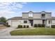 Two-story townhome with gray siding, attached garage, and front yard at 1903 Se 37Th Court Cir, Ocala, FL 34471