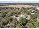 Wider aerial view of neighborhood with homes and trees at 19173 St Benedict Dr, Dunnellon, FL 34432