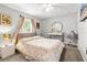 Bedroom with floral patterned bedspread and vanity at 19173 St Benedict Dr, Dunnellon, FL 34432