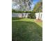 Landscaped backyard with a spacious lawn and mature trees at 2011 Se Twin Bridge Cir, Ocala, FL 34471