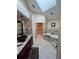 Luxurious bathroom featuring a soaking tub and skylight at 2011 Se Twin Bridge Cir, Ocala, FL 34471