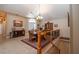 Open concept dining area with a large wooden table and chandelier at 2011 Se Twin Bridge Cir, Ocala, FL 34471