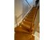 Elegant wooden staircase with built-in lighting at 2011 Se Twin Bridge Cir, Ocala, FL 34471