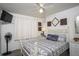 Cozy bedroom featuring a patterned bedspread and ceiling fan at 20820 River Dr # B17, Dunnellon, FL 34431