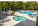 Community pool and spa with lounge chairs and patio tables at 20820 River Dr # B17, Dunnellon, FL 34431