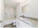 Modern bathroom with granite countertop vanity, marble-look tile, and vinyl flooring at 2295 Sw 142Nd Court Rd, Ocala, FL 34481