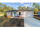 Newly built home with gray siding, teal front door, and garage at 2295 Sw 142Nd Court Rd, Ocala, FL 34481