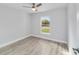 Bedroom featuring wood-look flooring, a ceiling fan, and a window with a view of the backyard at 2856 Sw 159 Ct, Ocala, FL 34481