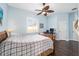 Bedroom with a queen bed, a work desk, and dark hardwood floors at 3819 Se 38Th Loop, Ocala, FL 34480