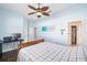 Bedroom with wood flooring, ceiling fan, and home office setup at 3819 Se 38Th Loop, Ocala, FL 34480