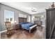 Main bedroom with dark hardwood floors, a ceiling fan, and plenty of natural light at 3819 Se 38Th Loop, Ocala, FL 34480