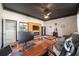 Home office with a wood-paneled accent wall and built-in shelving at 3819 Se 38Th Loop, Ocala, FL 34480