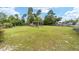 Large grassy backyard with a pergola and firepit at 4864 Sw 103Rd Street Rd, Ocala, FL 34476