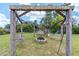 Relaxing backyard with firepit, pergola, swings, and hammock at 4864 Sw 103Rd Street Rd, Ocala, FL 34476