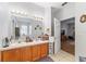 Bathroom with double vanity and a view of the bedroom at 4864 Sw 103Rd Street Rd, Ocala, FL 34476