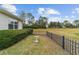 Landscaped backyard with bird bath and a black metal fence at 4911 Sw 63Rd Loop, Ocala, FL 34474