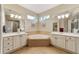 Bathroom features double vanity and corner soaking tub at 4911 Sw 63Rd Loop, Ocala, FL 34474