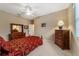 Bright bedroom with ceiling fan, dresser, and window coverings at 4911 Sw 63Rd Loop, Ocala, FL 34474