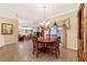 Elegant dining room with hardwood floors, chandelier, and views to living room at 4911 Sw 63Rd Loop, Ocala, FL 34474