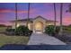 Community clubhouse at dusk with landscaping and pathway at 4911 Sw 63Rd Loop, Ocala, FL 34474