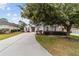 Charming single-story home with a large tree in the front at 4911 Sw 63Rd Loop, Ocala, FL 34474