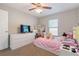 Cozy bedroom with a bed, dresser, and tv setup at 4947 Sw 166Th Loop, Ocala, FL 34473