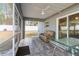 Relaxing screened porch with tiled floor and seating area at 4947 Sw 166Th Loop, Ocala, FL 34473