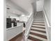 View of staircase and kitchen with modern appliances at 4947 Sw 45Th Cir, Ocala, FL 34474