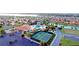 Aerial view of community with tennis courts and pool at 5015 Belted Kingfisher Dr, Oxford, FL 34484