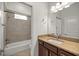 Bathroom boasts a vanity with granite countertop and a shower/tub combo at 5015 Belted Kingfisher Dr, Oxford, FL 34484