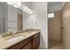 Bathroom with double vanity and walk-in shower at 5015 Belted Kingfisher Dr, Oxford, FL 34484