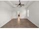 Bright bedroom with wood-look floors and an en-suite bathroom at 5015 Belted Kingfisher Dr, Oxford, FL 34484