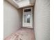 Front entry with white door and tile flooring at 5015 Belted Kingfisher Dr, Oxford, FL 34484