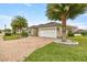 House exterior showcasing brick driveway and landscaping at 5015 Belted Kingfisher Dr, Oxford, FL 34484