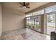 Bright Florida room with tiled floor and sliding glass doors at 5015 Belted Kingfisher Dr, Oxford, FL 34484