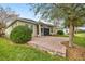 Brick paved patio with lush landscaping at 5015 Belted Kingfisher Dr, Oxford, FL 34484