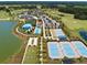 Aerial view of community pool, tennis courts, and lake at 5395 Nw 46Th Ln, Ocala, FL 34482