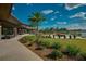 Modern clubhouse with outdoor seating overlooking a lake at 5395 Nw 46Th Ln, Ocala, FL 34482