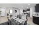 Open concept dining area with glass table and modern gray chairs at 5395 Nw 46Th Ln, Ocala, FL 34482