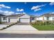 Two-car garage and landscaped front yard with brick pavers at 5395 Nw 46Th Ln, Ocala, FL 34482