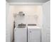 Bright laundry room with washer and dryer, and shelving for storage at 5395 Nw 46Th Ln, Ocala, FL 34482