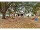 Large backyard with mature trees and a playset at 55 Almond Rd, Ocala, FL 34472