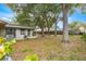 Spacious backyard with mature trees and a fenced area at 55 Almond Rd, Ocala, FL 34472